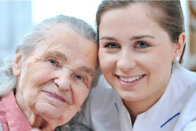 caregiver and old woman smiling