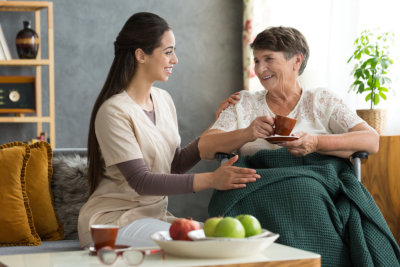 young caregiver serving the old lady