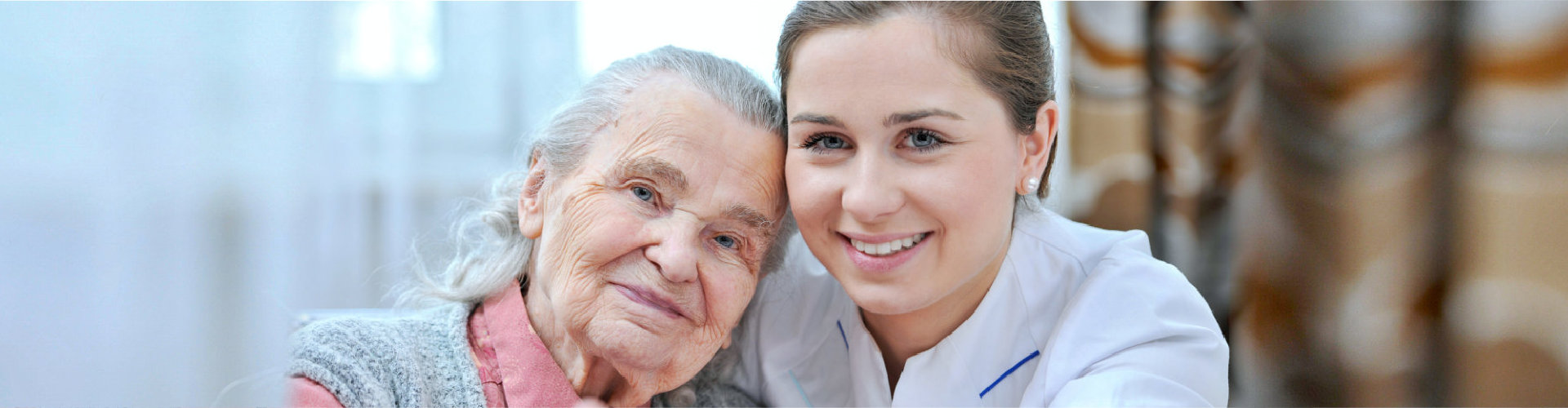 caregiver and old woman smiling